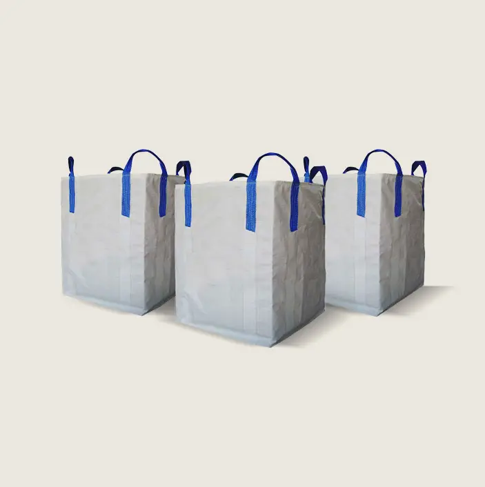 Three pristine white shopping bags with vibrant blue handles